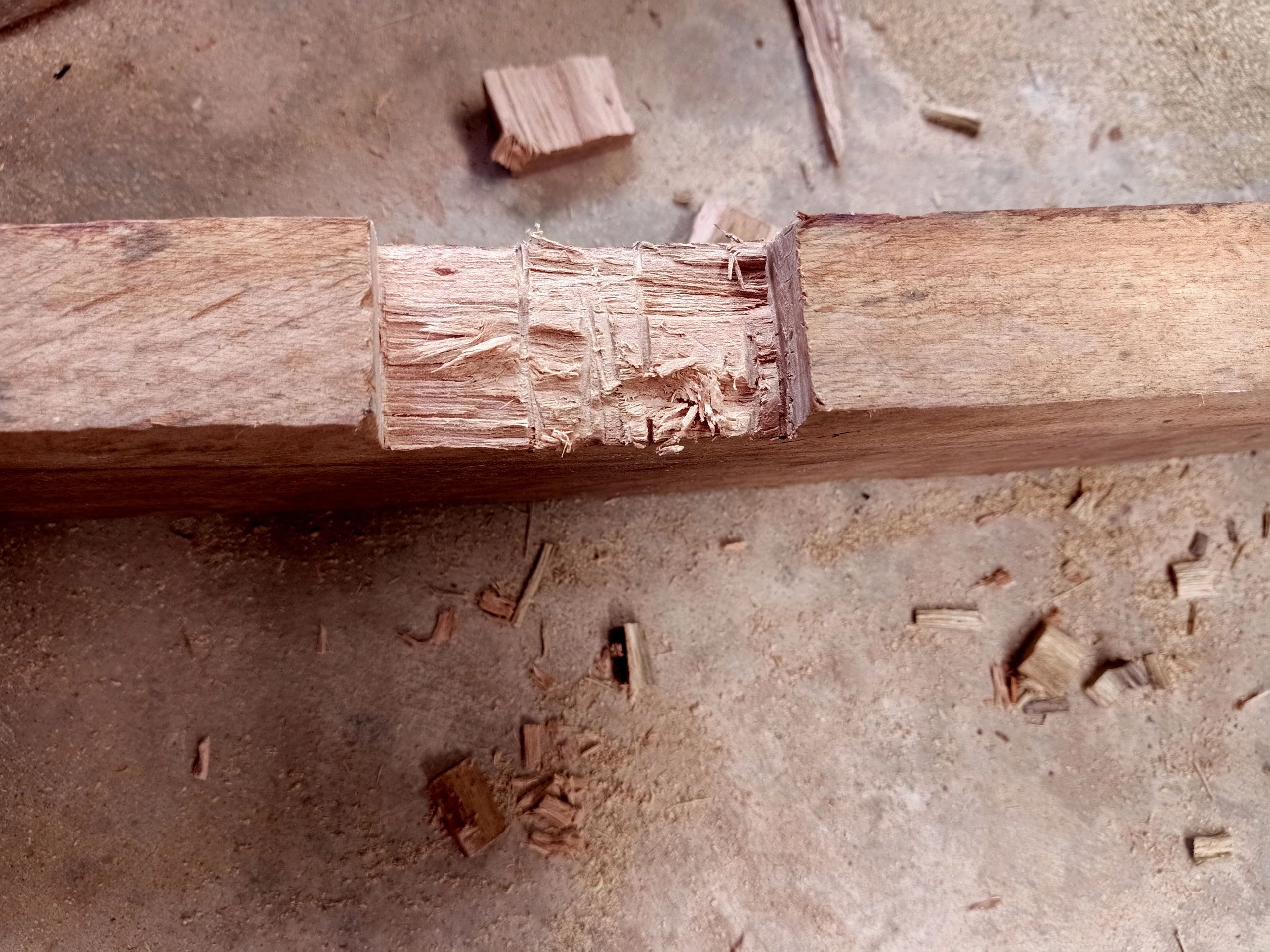 Carpenter shaping wood in a workshop