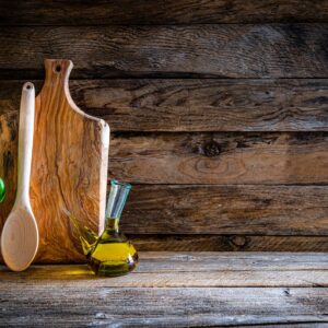 Cooking backgrounds: cutting board and kitchen utensils on wooden table. Copy space