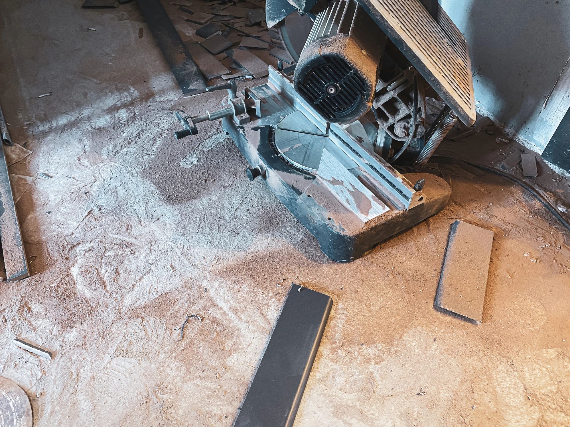 Miter saw and wood debris in an active workshop