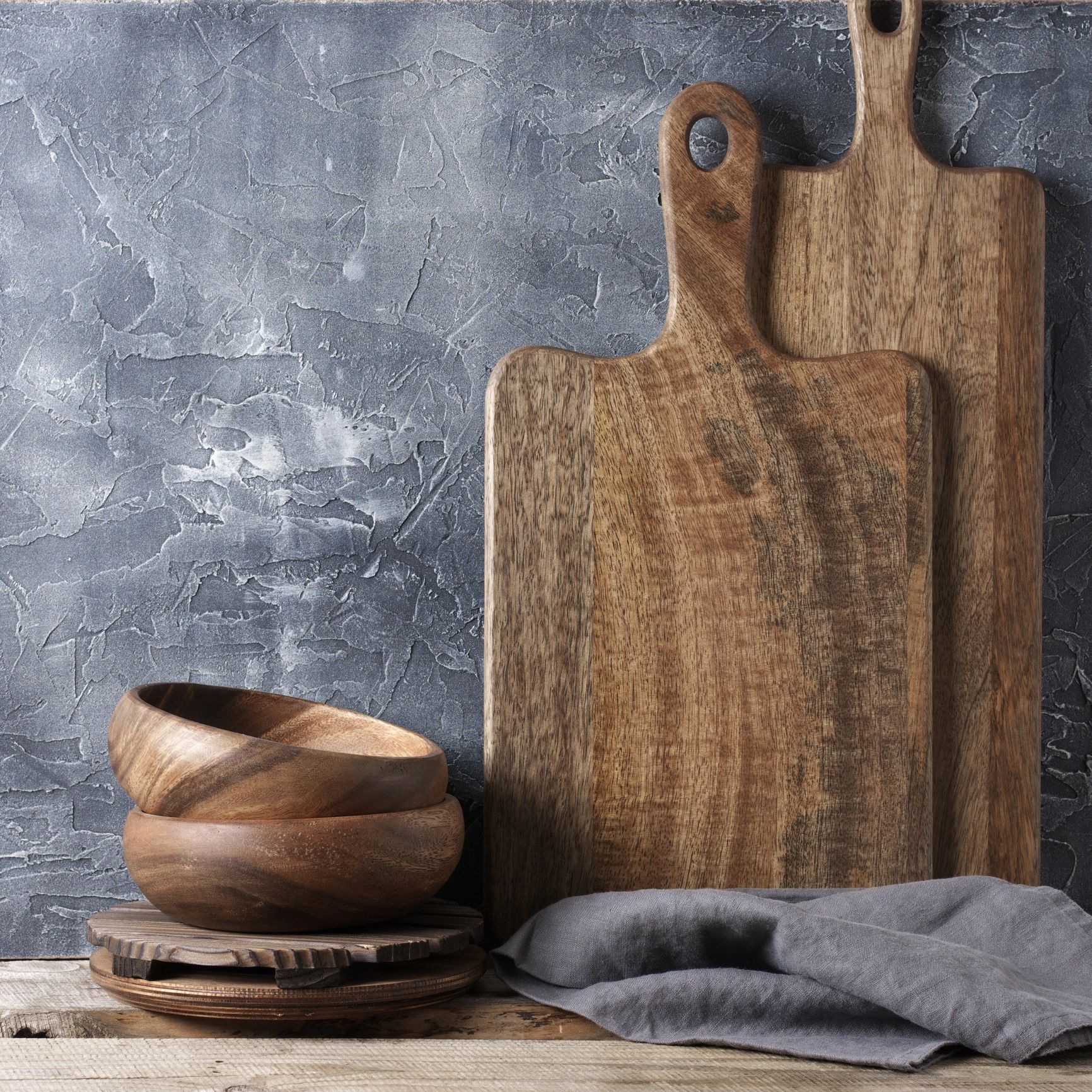Rustic wood kitchen display with cutting boards on shelf
